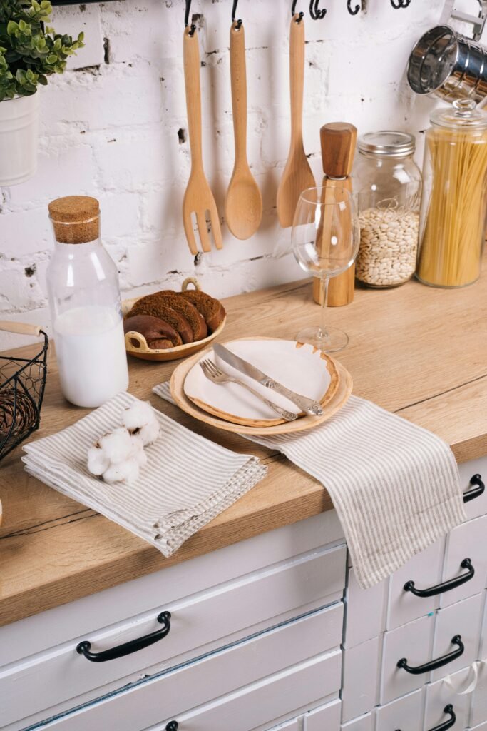 Charming rustic kitchen setup featuring wooden utensils, plates, and natural elements on a cozy countertop.