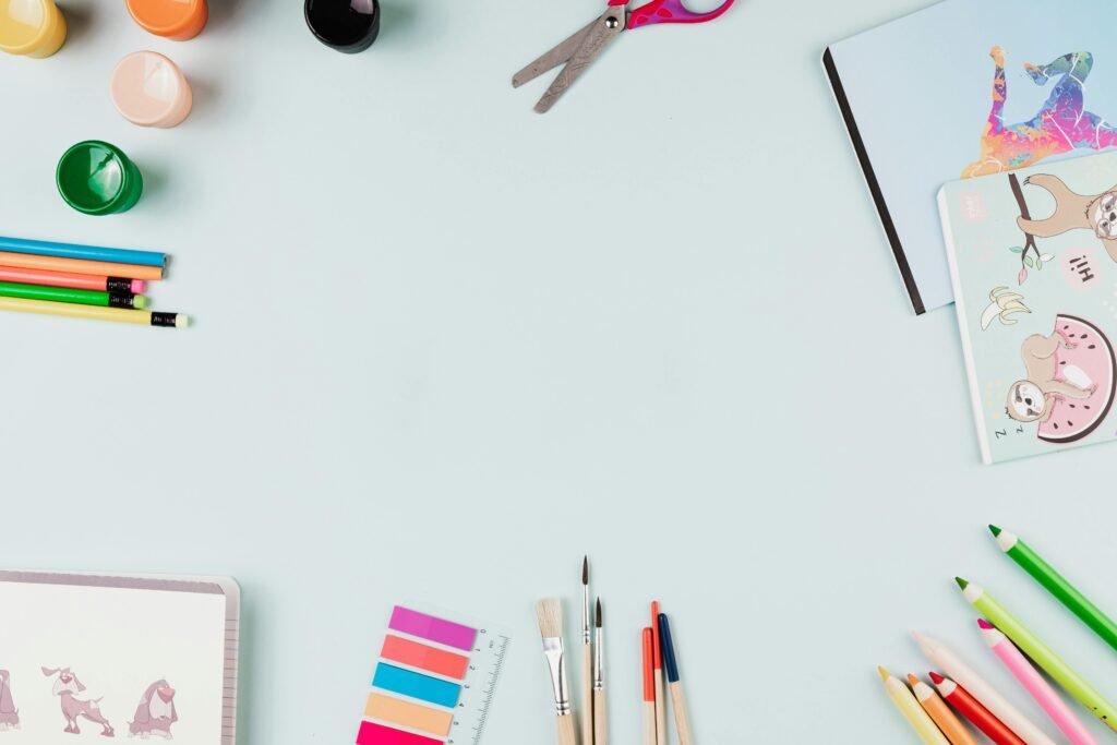 homeschool must-haves, Top-view flat lay of art supplies on a pastel surface with ample copy space.